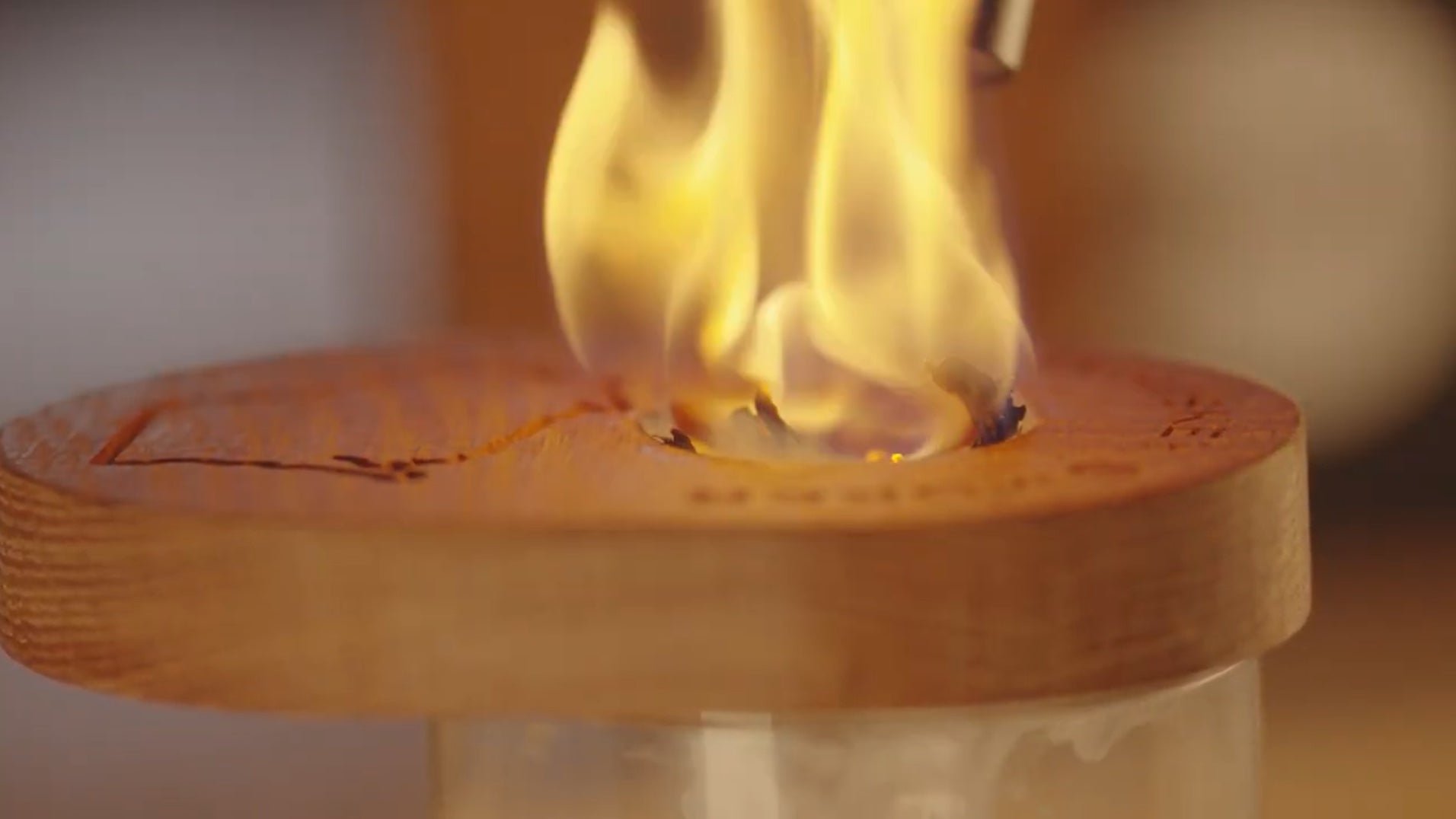 Load video: A video demonstrating how a whiskey smoker works, close up shots of the flame, the smoke and the whiskey smoker.